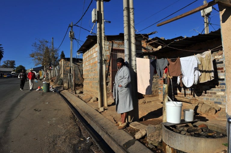 Electricity lines hang above a shack in the Alexandra township of Johannesburg. Photo: Alexnder Joe/AFP