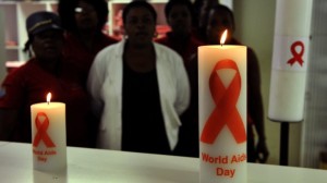A photo taken in November 2013 shows staff members of the Themba Lethu Clinic in Johannesburg, the largest antiretroviral treatment site in the country, posing behind candles commemorating World Aids Day on December 1. Photo: AFP/Alexander Joe