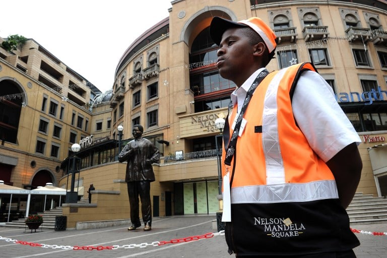 A security guard on duty outside a luxury Johannesburg hotel. Photo: AFP/Fabrice Coffrini