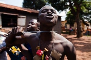 An anti-balaka fighter, member of a militia opposed to the Seleka rebel group, putting a knife to his throat showing what he would do to any Seleka. Photo: AFP/Ivan Lieman