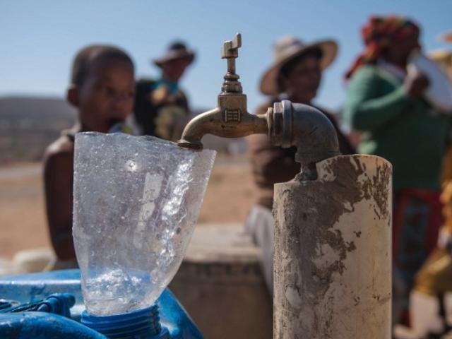 Residents of drought-stricken Nongoma in KwaZulu-Natal prepare to collect water from a free water point sponsored by concerned citizens in November 2015. Photo: AFP/MUJAHID SAFODIEN
