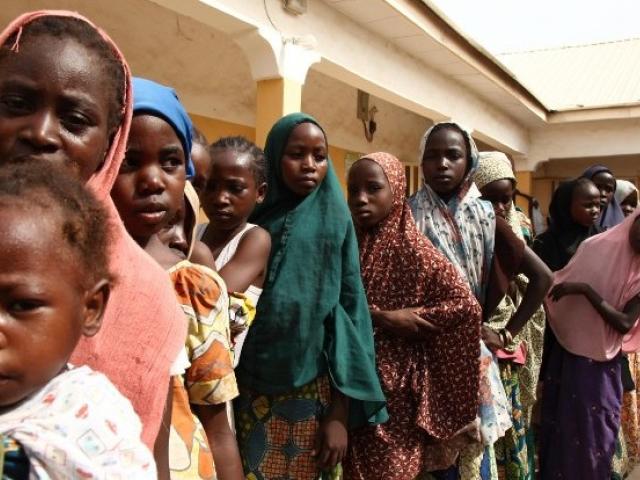 Girls rescued by Nigerian soldiers from the terrorist group Boko Haram in the Sambisa Forest line up to collect donated clothes at a refugee camp in Yola in May 2015. Photo: AFP/EMMANUEL AREWA