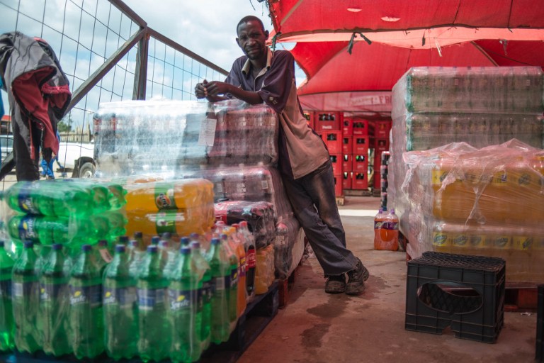 A man sells soft drinks in bulk at a shop in Zandspruit township in greater Johannesburg in March 2016. Photo: AFP/MUJAHID SAFODIEN