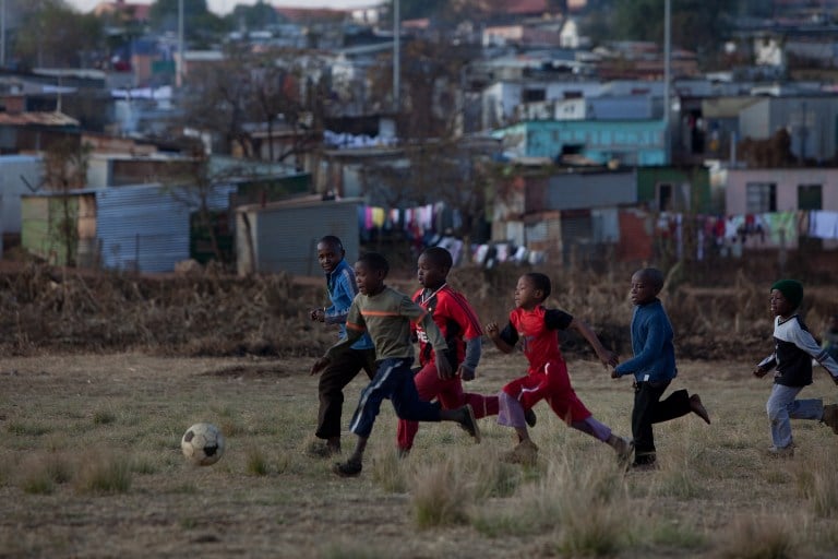 A group of children play football in Soweto. Photo: AFP/Yasuyoshi Chiba