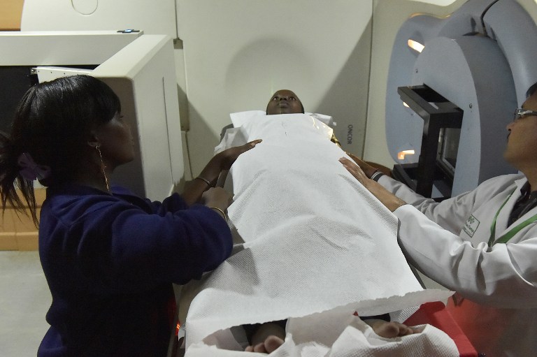 Radiation therapists prepare a patient for a radiation session at the Cancer Care Kenya centre in Nairobi on in December 2016. Photo: AFP/SIMON MAINA