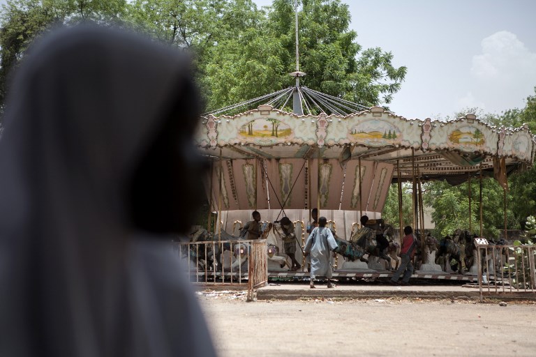 Children orphaned by Boko Haram members play on a merry-go-round in an abandoned amusement park in Maiduguri, Nigeria, in April 2017. Photo: AFP/Florian Plaucheur