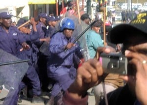 Police attack protesters in central Mbabane 13 August 2003. Thousands of people took to the streets of the city to protest the lack of the rule of law in the country as heads of state arrived to attend the 2003 Smart Partnership International Dialogue.