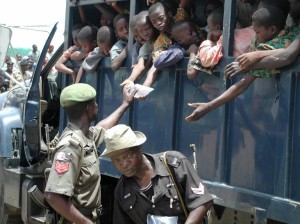 This photo taken on September 26, 2003 shows dozens of slave children being given water in the back of a police vehicle after their apprehension at the Seme border as they were being conveyed to Benin.  Photo: AFP