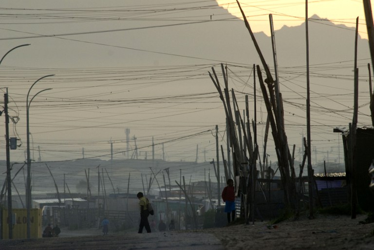 A 2010 file picture of a boy walking to school in an informal settlement in Khayelitsha, a poor area of shacks about 30 kms east of the center of Cape Town. Photo: AFP/Rodger Bosch