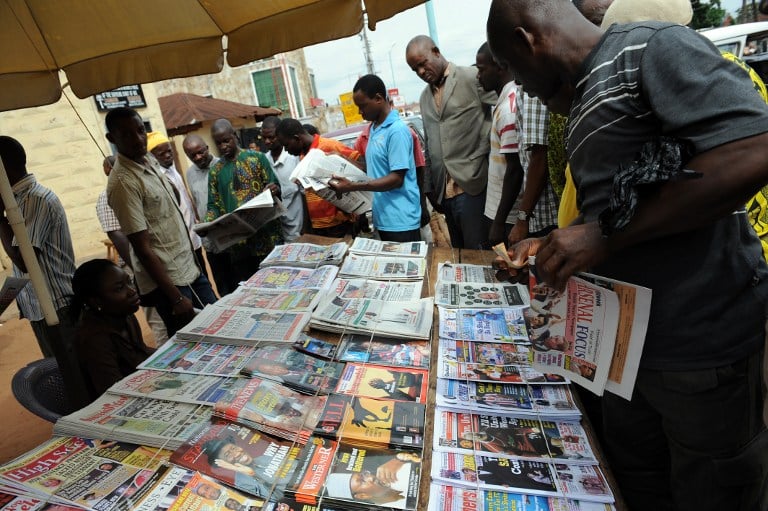 At a roadside in Delta state, people read about the results of Nigeria's 2011 presidential election. The winner, Goodluck Jonathan, was the first president from the oil producing Niger Delta region. Photo: AFP/Pius Utomi Ekpei