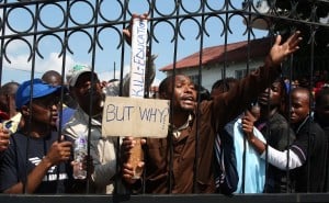 Students from the University of Swaziland, locked inside the campus grounds, ask police officers to let them out during a protest in Mbabane on November 3, 2011.Photo: AFP/Jinty Jackson