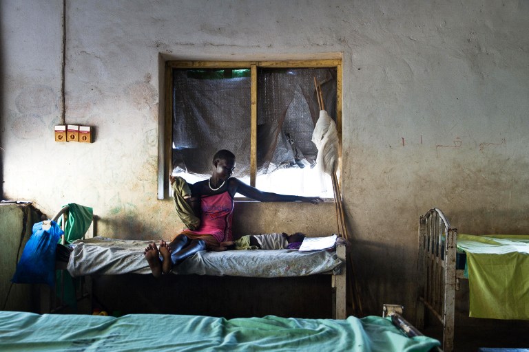 A mother watches over her baby suffering from malaria at a teaching hospital in Malakal, South Sudan, in September 2012. Photo: AFP/Camille Lepage