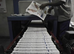 Copies of China Daily roll of a printing press in Nairobi. Photo: AFP/Tony Karumba