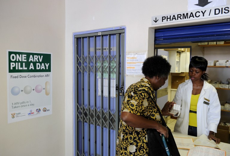 A woman receives medication at the Phedisong Clinic pharmacy on April 8, 2013 during the launch of the new single dose anti-AIDS drug in Ga-Rankuwa,100 kms north of Johannesburg. Photo: AFP/Stephane de Sakutin