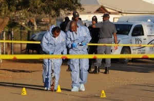 South African crime scene experts work at the scene of the shooting of a union leader who was killed inside the National Union of Mineworkers offices by two unknown gunmen, in Marikana on June 3, 2013. Photo:AFP/Stringer