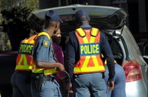 South African Police Service members search a vehicle. Photo: AFP/Alexander Joe