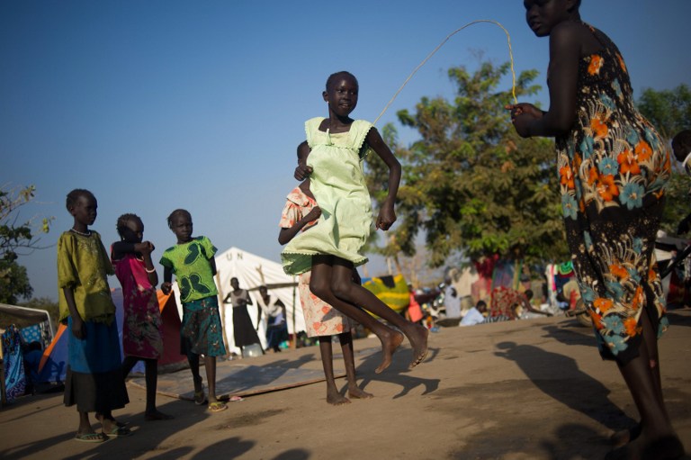 Girls skip a rope at a camp for internally displaced persons at the base of the United Nations mission in South Sudan in Juba in January 2014. Photo: AFP/PHIL MOORE