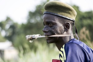 A member of the mainly Christian "anti-balaka" militia holds a blade in his mouth as he trains in the Boeing neighbourhood of Bangui, Central African Republic, on February 24, 2014. Photo: AFP/Fred Dufour