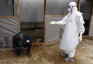 A man thought to be infected with the Ebola virus waits to be treated at a hospital in Monrovia. Photo: AFP/ Pascal Guyot