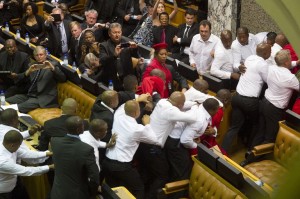 The men in "white shirts" clash with members of the Economic Freedom Fighters in Parliament this week. Photo: AFP/Rodger Bosch