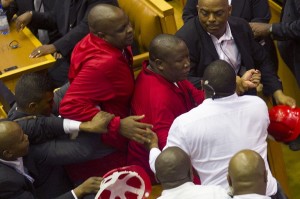 EFF leader Julius Malema is manhandled by the 'white shirts' in Parliament this week. Photo: AFP/Rodger Bosch