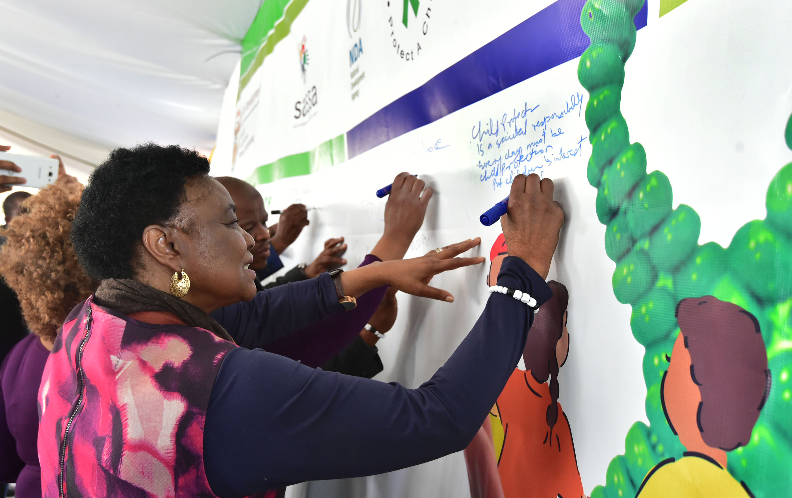 South Africa's minister of home affairs, Hlengiwe Buhle Mkhize, signs a pledge in support of child protection in Langa, Cape Town, in May 2017. Photo: Kopano Tlape/GCIS