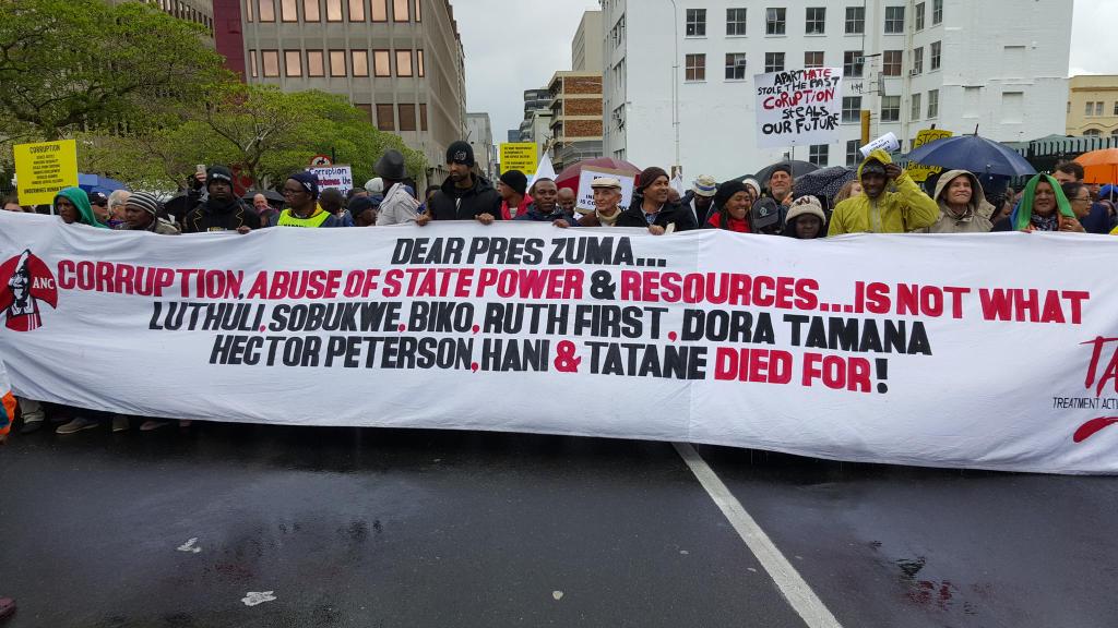 A marcher at Cape Town's Unite Against Corruption March hold a banner which claims R700 billion has been lost to corruption in 20 years. Photo: @ONEBLOODSA