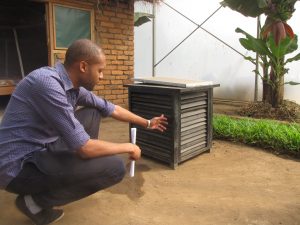 Arnold Mmbando, an Ifakara Health Institute researcher, examines a locally made solar-powered bug zapper. Photo: Jon Greenberg