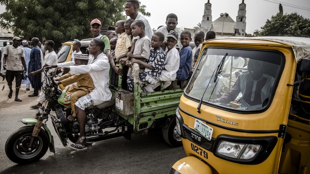 A group of Muslim men and children ride a moto taxi after Friday prayers in the Nigerian city of Mubi, Adamawa State, on February 15, 2019, on the eve of the country's presidential electionr. Photo: AFP/LUIS TATO