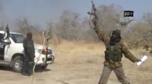 Boko Haram leader Abubakar Shekau fires an assault rifle in the air in a screen grab from the YouTube video in which he claimed responsibility for the Baga killings.