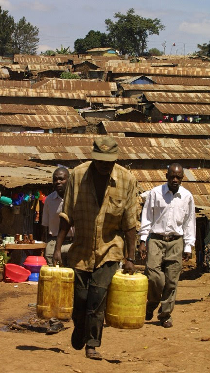 A resident of Nairobi's Kibera slum fetches water in July 2005. Photo: AFP/SIMON MAINA