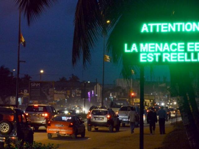 A sign that says "[w]atch out ! The Ebola threat is for real" is displayed in downtown Abidjan, Ivory Coast, as part of steps to prevent the deadly virus from reaching this West African nation. Photo: AFP/Issouf Sanogo