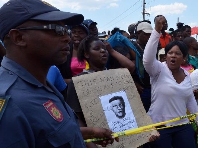 Protesters demonstrated in October 2013 in Diepsloot, north of Johannesburg, after five people were arrested for the rape and murder of two toddlers in the informal settlement. Photo: AFP/Alexander Joe