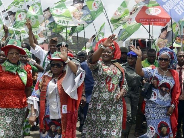 The first lady of Nigeria, Patience Jonathan (second from the left), waves as she arrives at a rally to campaign for her husband, President Goodluck Jonathan, ahead of the country's election on 28 March. Photo: AFP/Pius Utomi Ekpei
