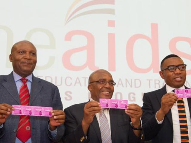 As part of the "First Things First" HIV counselling and testing campaign for students, health minister Aaron Motsoaledi (middle) and deputy minister of higher education, Mduduzi Manana (right), holds up new flavored condoms to be distributed to campu