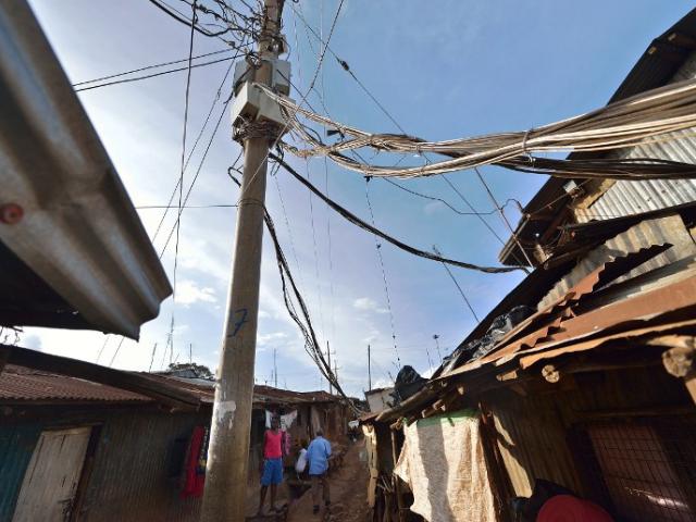 A study of electricity supply in Kenya found that only 30% of Kenyans are connected to the national grid. This picture shows an electricity pole in a Nairobi slum in March 2015. Photo: AFP/Tony KARUMBA