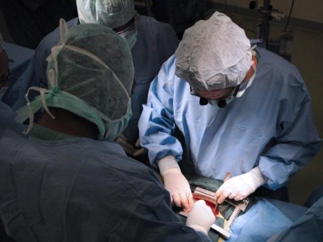 Surgeons from the French NGO Chaine de l'Espoir (Chain of Hope) and the Abidjan Institute of Cardiology perform a heart surgery on one of the 20 children suffering from cardiac problems at the Institute of Cardiology in Abidjan on March 24, 2009. Pho
