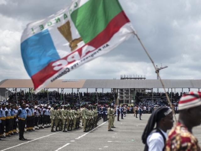 A man carries a flag of Nigeria's ruling All Progressive Congress (APC) party during a Democracy Day parade on 29 May 2017 in Freedom Square in Owerri. Photo: AFP/STEFAN HEUNIS