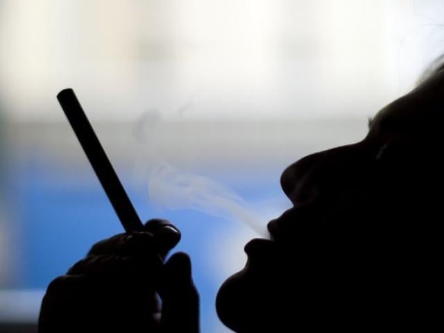This September 2013 photo illustration shows a woman smoking an e-cigarette in Washington DC. Photo: AFP/Jim Watson