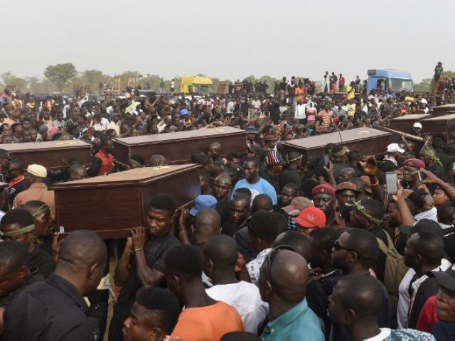 Pallbearers carry the coffins of people killed during clashes between mainly Muslim Fulani herdsmen and Christian farmers. The funeral took place in January 2018 in the Benue state capital of Makurdi. Photo: AFP/PIUS UTOMI EKPEI