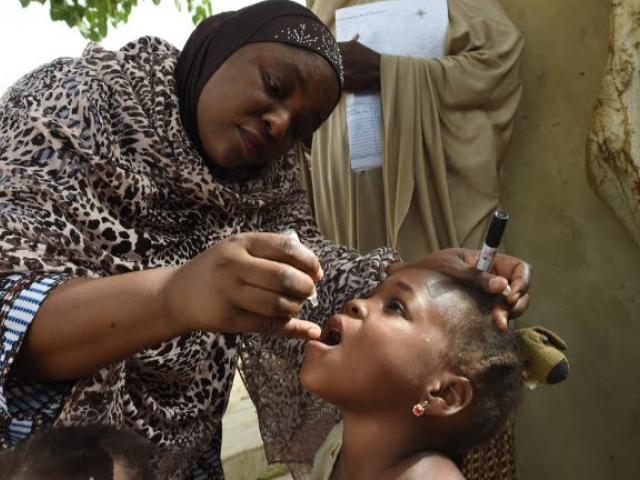 Unicef health consultant Hadiza Waya immunises a child during a vaccination campaign against polio at Hotoro-Kudu, Nassarawa district of Kano in northwest Nigeria on April 22, 2017. PHOTO: AFP/ Pius Utomi Ekpei