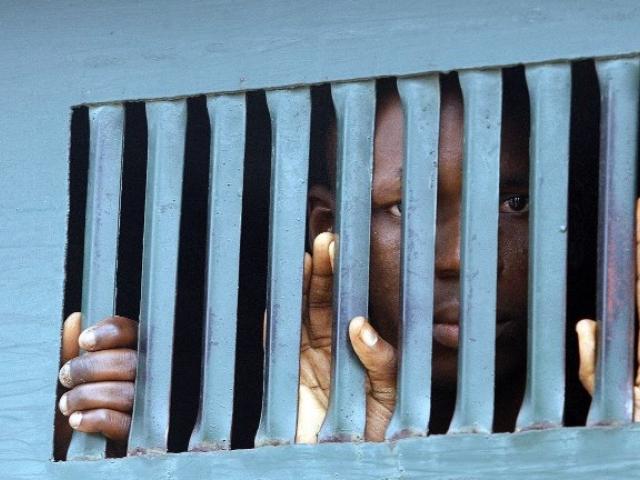 A man arrested for contravening the sharia penal code waits to be taken to prison after a hearing in Bauchi in August 2007. Photo: AFP/PIUS UTOMI EKPEI