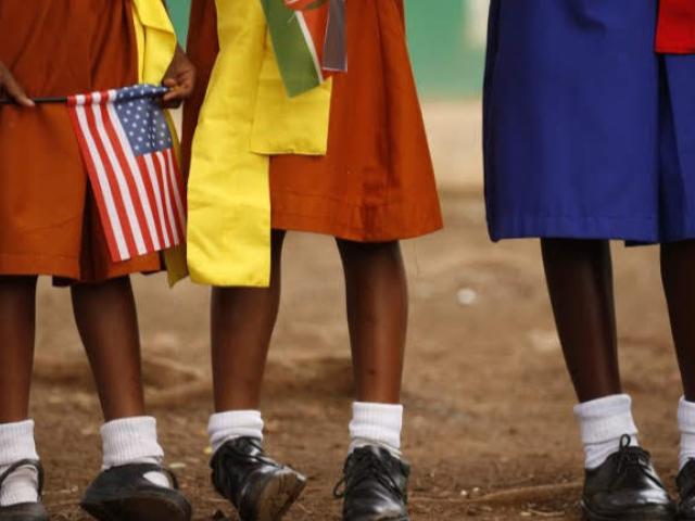 Young girls with US and Kenya flags wait to greet US Ambassador to Kenya Robert Godec as he visited a President's Emergency Plan for AIDS Relief (PEPFAR) project for girls' empowerment in Nairobi on March 10, 2018.Photo: AFP/POOL/JONATHAN ERNST