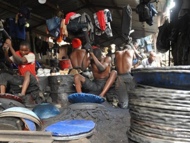 Young Kenyan blacksmiths make frying pots from iron sheetss at the Kamukunji market in Nairobi in 2012. Youth unemployment remains a persistent problem in Kenya. Photo: AFP/ SIMON MAINA