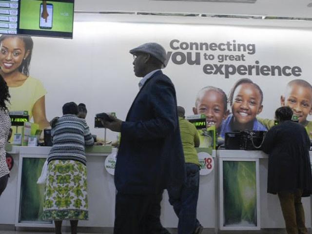 Clients are seen at a mobile phone centre in Nairobi, Kenya in November 2018. Photo: AFP/ SIMON MAINA