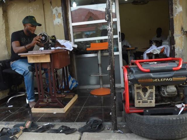 A tailor uses a generator for power due to the epileptic public power supply in Lagos on September 2016. Even at the best of times Nigeria, which is home to more than 170 million people, ranks among the lowest countries in the world for energy consum