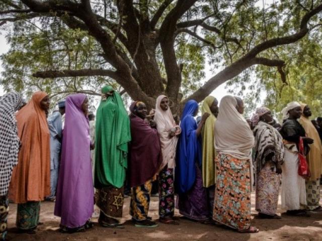 Muslim women queuing in line 
