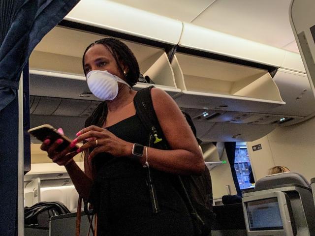 Woman wearing face mask on plane 