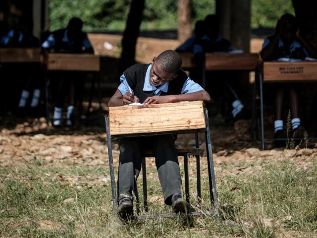 Kenya high school students sit an exam