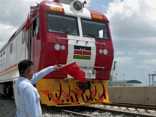 A man waves a red flag during the launch of Standard Gauge Railway freight locomotives at Mombasa Por